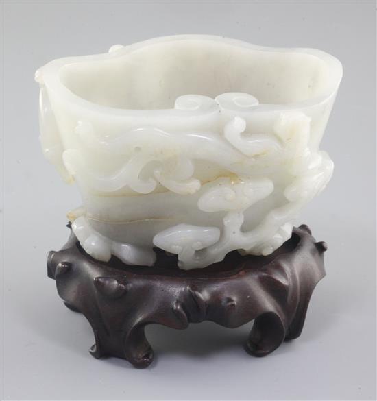 A Chinese greyish-white jade cup or brushwasher, 12cm, wood stand